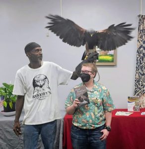 Rodney Stotts, his falcon and a library staff member