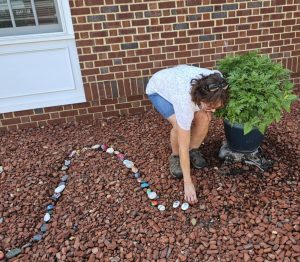Martha adding rocks to Squirm the Book worm
