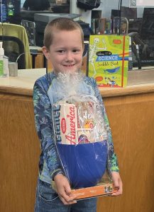 Leo pictured here with his mother Angel’s winning “Science Across America” raffle haul